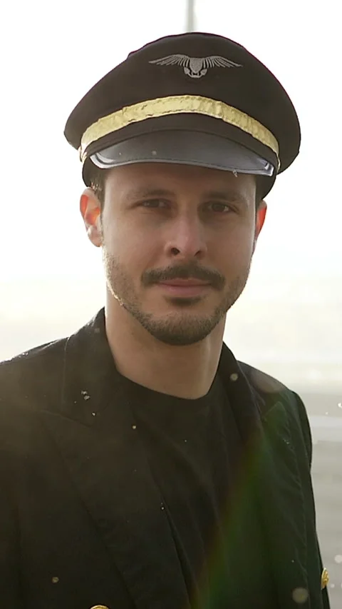 A Professional Pilot Dressed in Uniform Posing Against a Beautiful Scenic Stock Footage 287862807