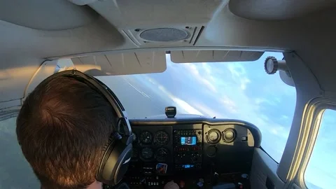 Professional pilot is operating a small plane, turning in the air, landscape Stock Footage 149710045