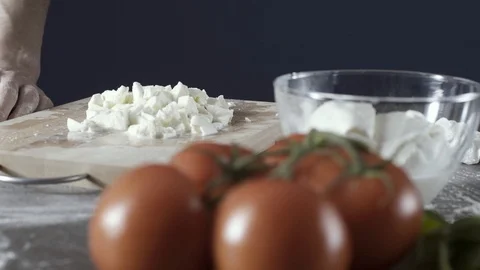 Professional pizza maker adding mozzarella cheese on the dough Stock Footage 127414753