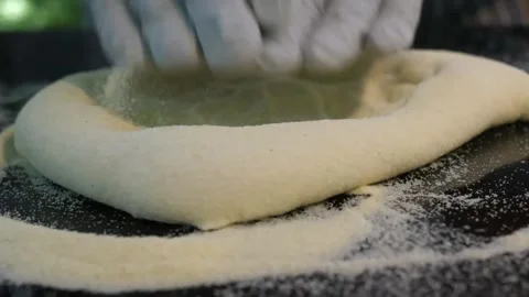 Professional Pizzaiolo Hands Stretching Raw Pizza Dough on Semolina Flour Stock Footage 337676677