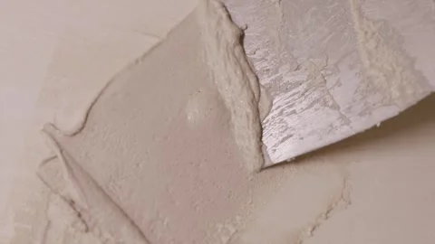 Professional plasterer smoothing drywall compound on wall Stock Footage 340610713