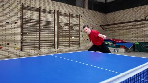 A professional player does a forehand top-spin during training on a blue tabl.. Stock Footage 323319305