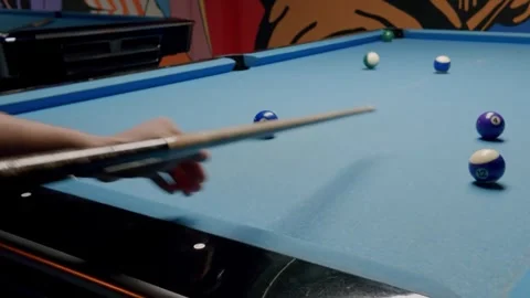 Professional player hitting a cue ball during a billiards game Stock Footage 346770212