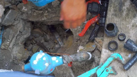 Professional plumber hands installing black plastic pipe fitting in concret.. Stock Footage 331898038
