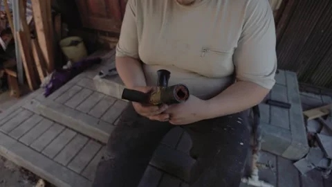 Professional plumber holding a section of an old, calcified water pipe, showing Stock Footage 326655203