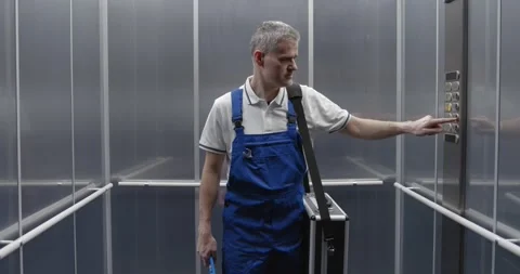 Professional plumber taking the elevator Stock Footage 308916278