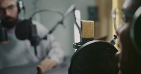Professional Podcast Recording Session With Two Male, Hosts and Guest, Capturing Video stock 322099287