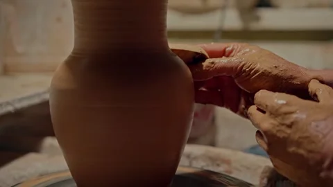 Professional potter makes vase. Using sponge to fix form. Sculpting the clay Stock Footage 254154392