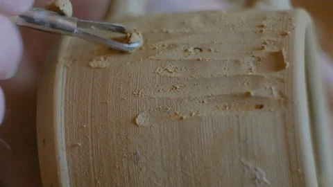 Professional potter making pattern on clay mug with special tool in workshop Stock Footage 101371324