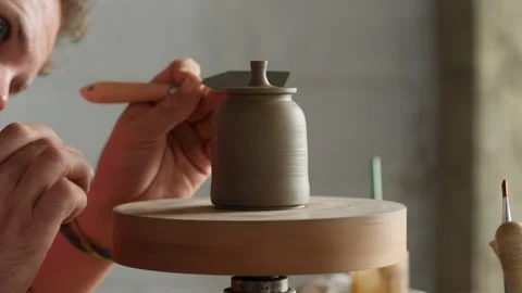 Professional potter shaping the lid of the clay teapot on the potter's wheel Stock Footage 145543933