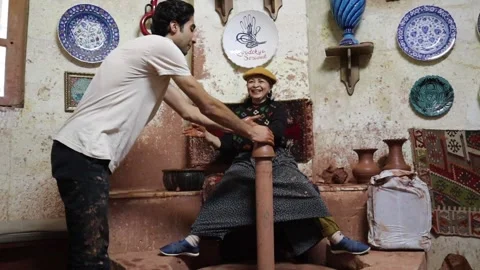 Professional pottery man teaches process how to making ceramic to tourist Video stock 245267977