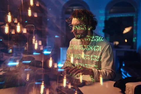 Professional programmer doing his job on computer in dark office Foto stock