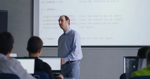 Professional Programmer Man Teaching Young School Students, Portrait Of Man In Stock Footage 281938734