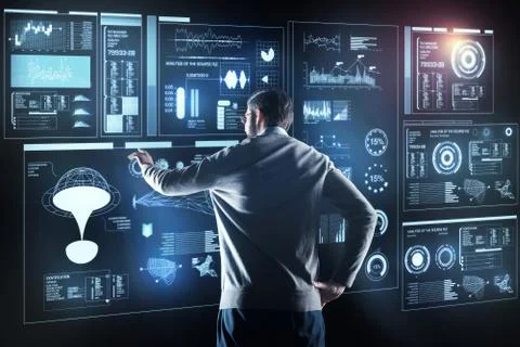 Professional programmer standing alone and looking at the screen Foto stock