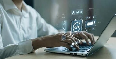 Professional programmer working on agile software development with laptop and Stock Photos