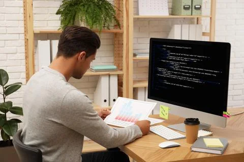 Professional programmer working with computer in office Foto stock