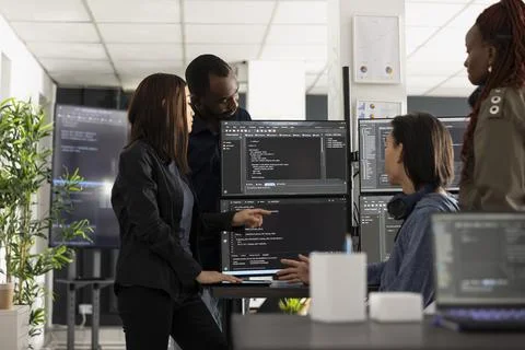 Professional programmers collaborating on digital project 스톡 사진