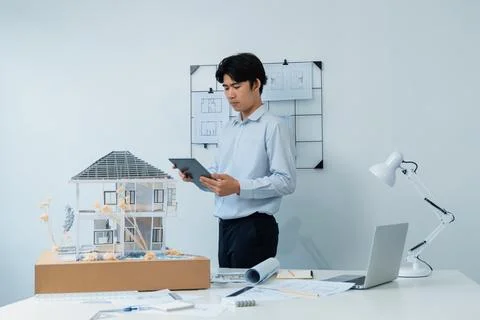 Professional project manager using tablet to check house model. Immaculate. 写真素材