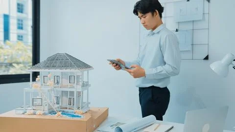 Professional project manager using tablet to check house model. Immaculate. 스톡 사진