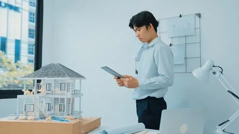 Professional project manager using tablet to check house model. Immaculate. 写真素材