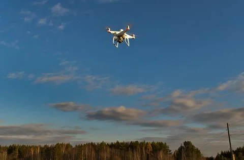 Professional quadcopter with high resolution camera onboard doing its job Stock Photos