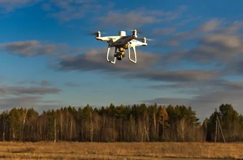 Professional quadcopter with high resolution camera onboard doing its job Stock Photos