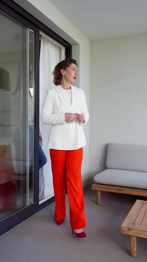 Professional real estate agent guiding a female client onto the balcony of .. Stock Footage 332431087