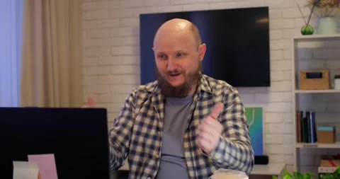 Professional remote worker with beard, wearing plaid shirt, joining virtual Stock Footage 301524672