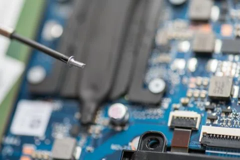 Professional repair of computers, laptops, boards. Screwdrivers, macro, close Stock Photos