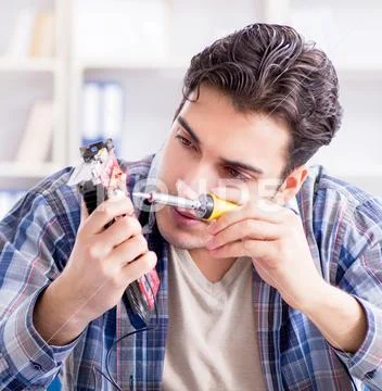 Professional repairman repairing computer in workshop Stock Photos