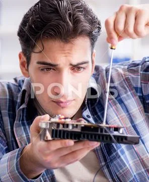 Professional repairman repairing computer in workshop Stock Photos