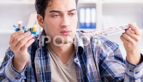 Professional repairman repairing computer in workshop Stock Photos