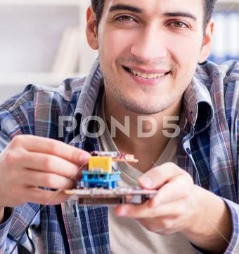Professional repairman repairing computer in workshop Stock Photos
