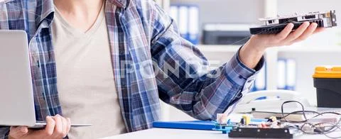 Professional repairman repairing computer in workshop Stock Photos