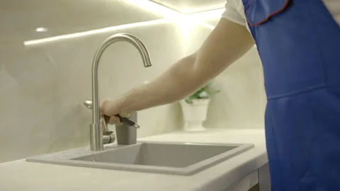 Professional repairman solving plumbing problem in kitchen, house maintenance Stock Footage 152567567