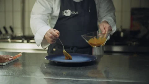Professional restaurant chef cooking fish wrapped in mortadella on a skillet ove Stock Footage 199460618