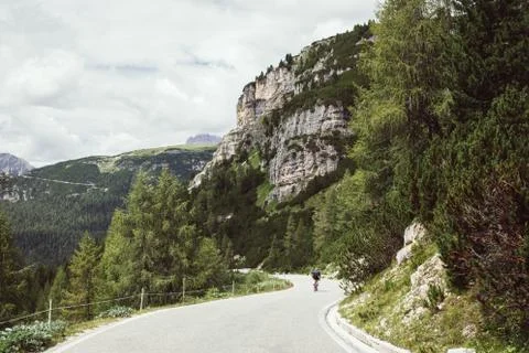 Professional road cyclist on training trip in alps Stock Photos