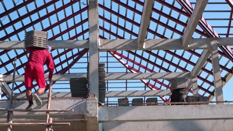 A professional roofer specializing in tile roofing is lifting tiles up a la.. Stock Footage 300078279