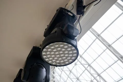 Professional rotating LED spotlight mounted on ceiling structure. Stock Photos