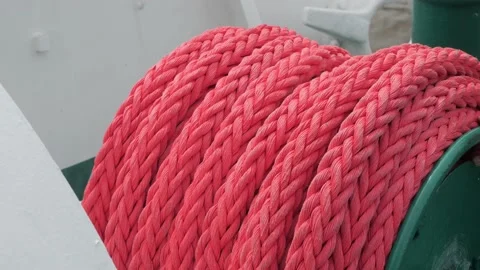 Professional sailor hands wind-up large new rope on coil Stock Footage 155286263