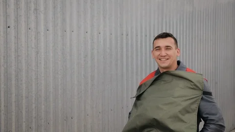 Professional Sand Blasting Worker Takes off His Hardhat and Overalls Stock Footage 128263106