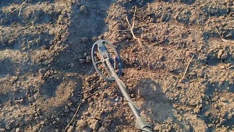 A professional sapper searches for a minefield using a metal detector. Stock Footage 290121016