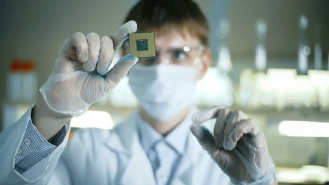 Professional scientist holding and observing the micro chip Video stock 70522204