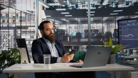Professional scrolling on mobile phone apps and taking break from office tasks Stock Photos
