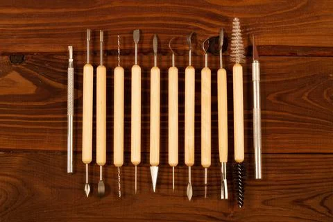 Professional sculpting tool kit for polymer clay and wax on wooden background Stock Photos