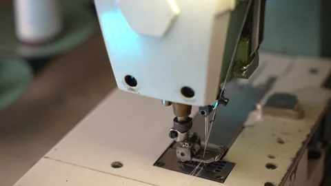 Professional seamstress fixing white thread with needle in sewing machine Video stock 252427643