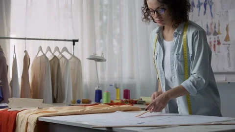 Professional seamstress marking patterns, considering dimensions of customer Stock Footage 84946851