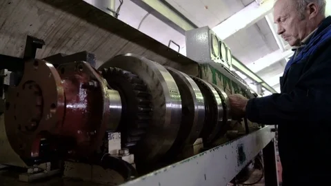 Professional senior mechanic adjusts the machine. Repair transmission unit Stock Footage 75137984