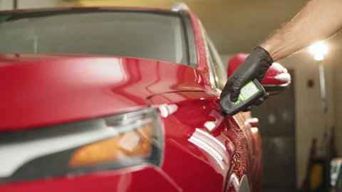 Professional service specialist testing thickness of the car paint. Coating Stock Footage 233575913