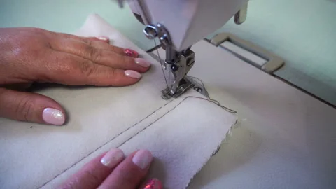 Professional sewing machine, middle-aged woman's hands Stock Footage 90377475